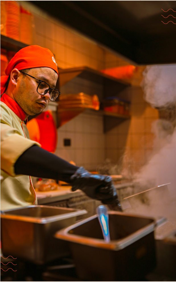 A GRIP cook working at the kitchen station