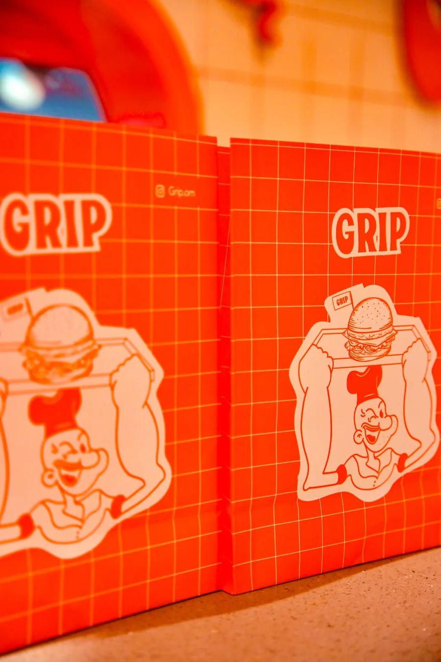GRIP branded paper bags with the chef illustration